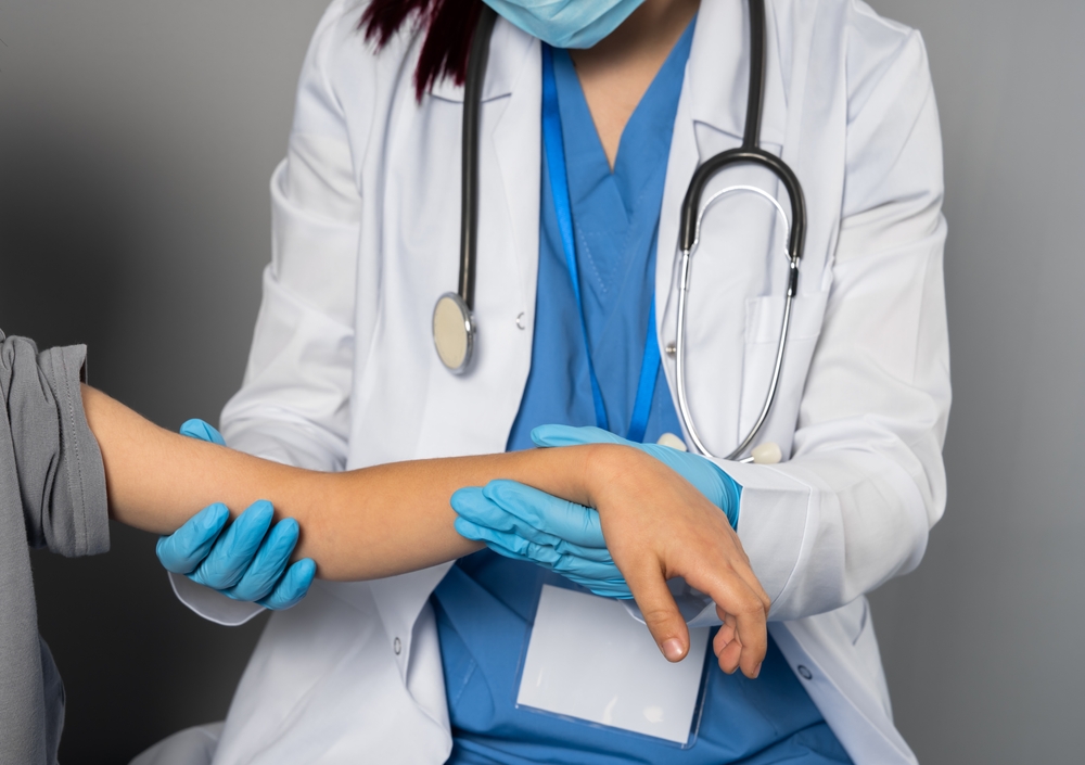 Doctor,Examining,Childs,Arm,For,Fracture